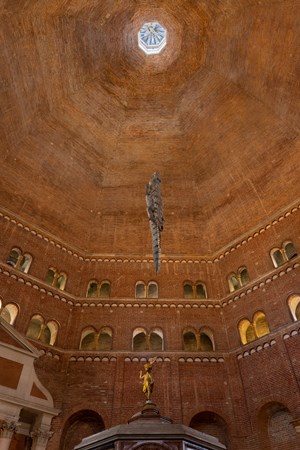 Maurizio Cattelan Hangs a Stuffed Crocodile at the Baptistery of Cremona