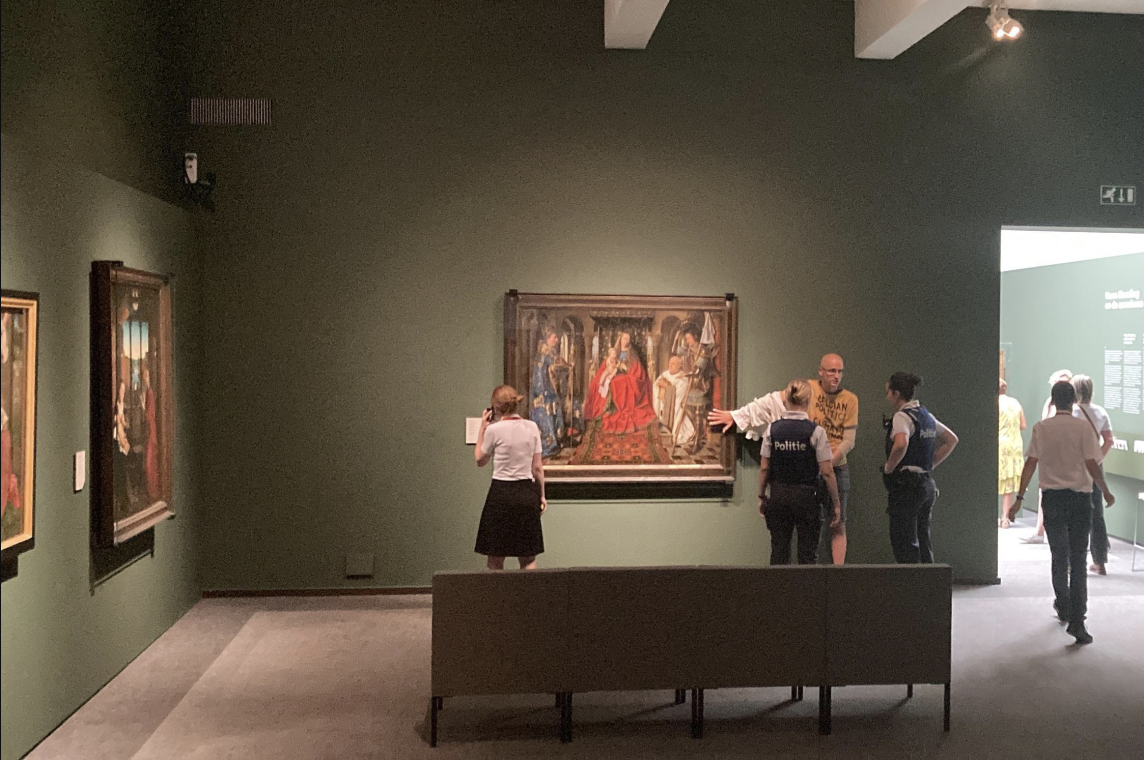 Climate Activist Glues Self to Safety Glass of Famous Jan van Eyck Painting Exhibited in Bruges